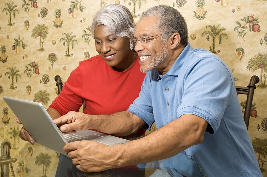 Happy older couple using a computer