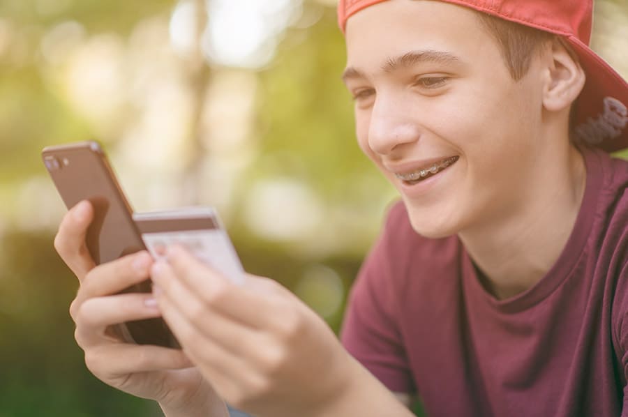 Teen male using mobile banking
