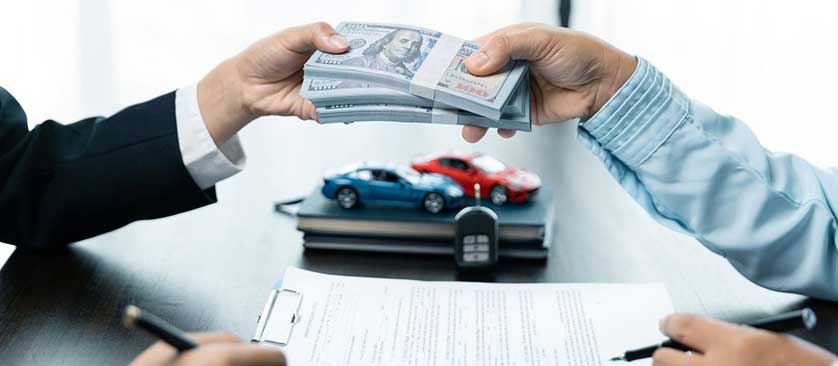 customer signing auto loan application