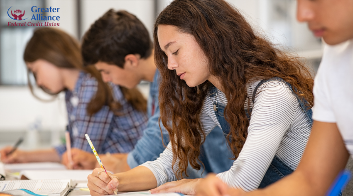 college students completing written classroom assignments