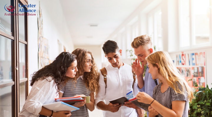 college students reviewing study materials in hallway