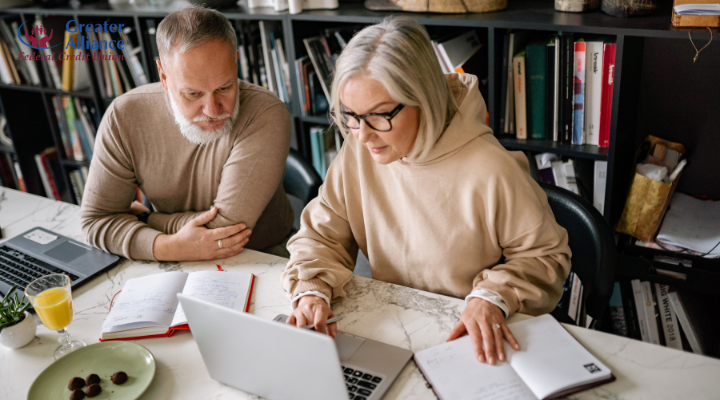 senior couple planning retirement finances on laptop