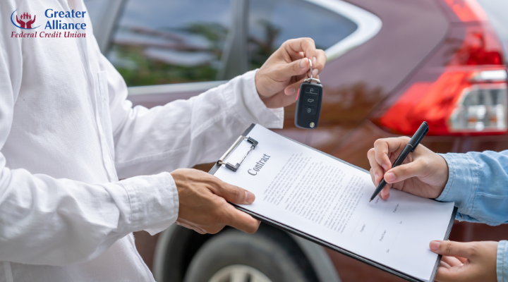 signing a car purchase contract beside a vehicle