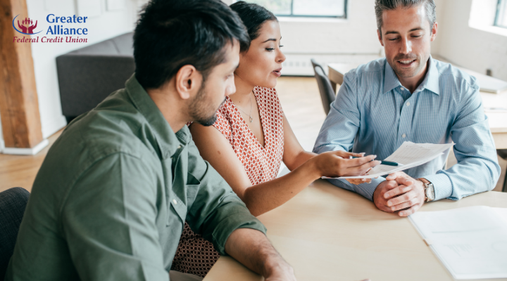 couple discussing mortgage documents with a loan advisor